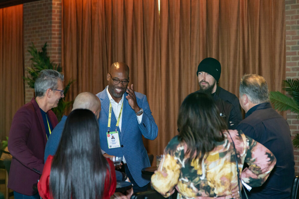Professionals talking and laughing at a corporate reception in Las Vegas