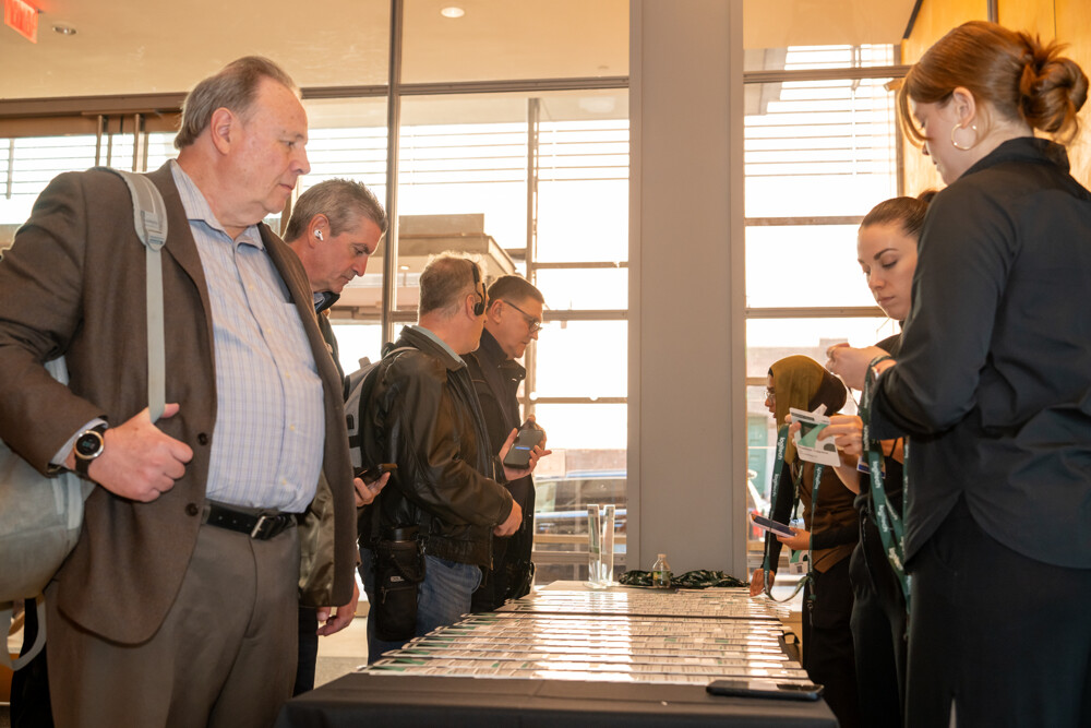 Attendees check in at a conference registration table